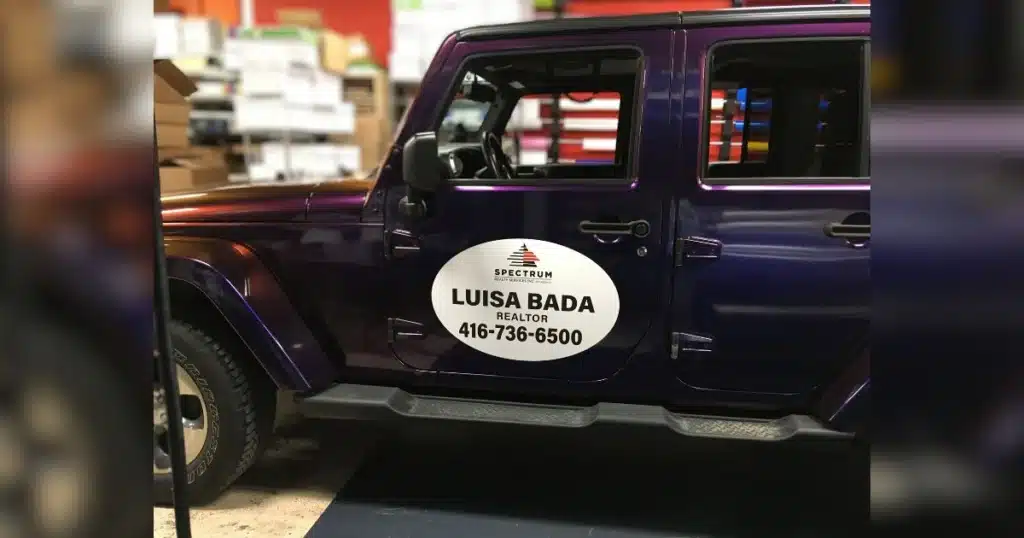 Realtor decals shown on the driver's side of the Jeep Wrangler.