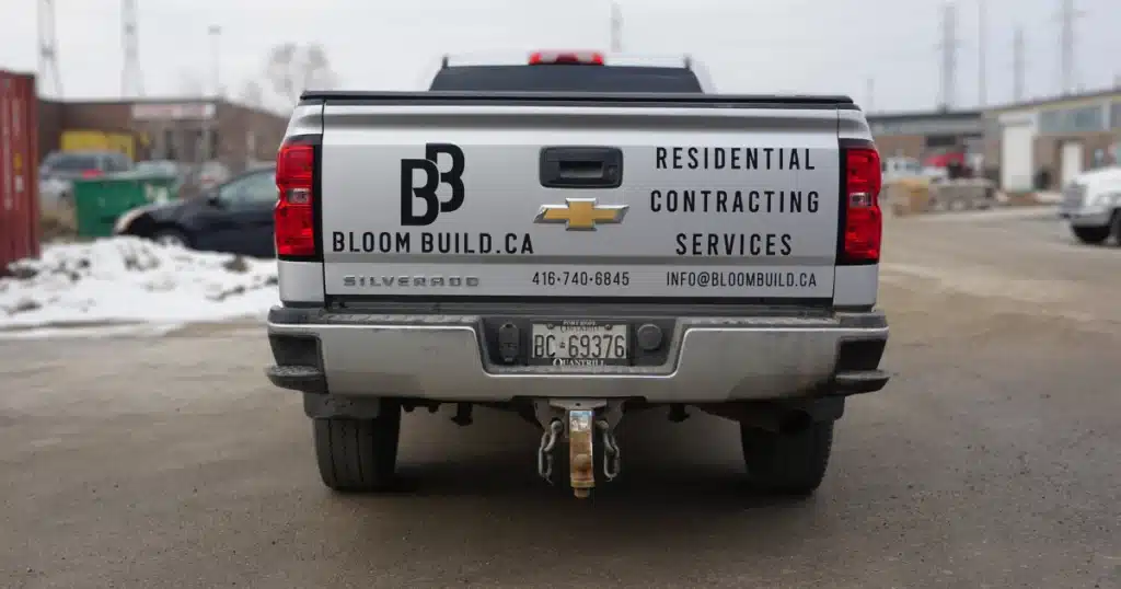 Bloom Build truck graphics at the tailgate of their Chevy Silverado.