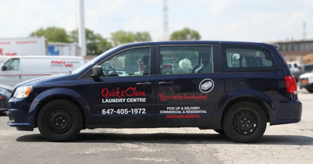 Side view of a Dodge Caravan Navy displayed with decals