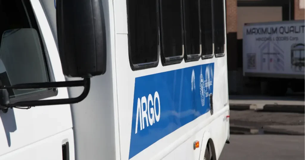 Close up shot of a Ford E350 displayed with a partial wrap and decals