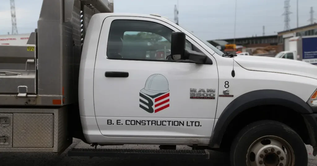 Close-up view of B.E. Construction LTD decals on a Dodge Ram