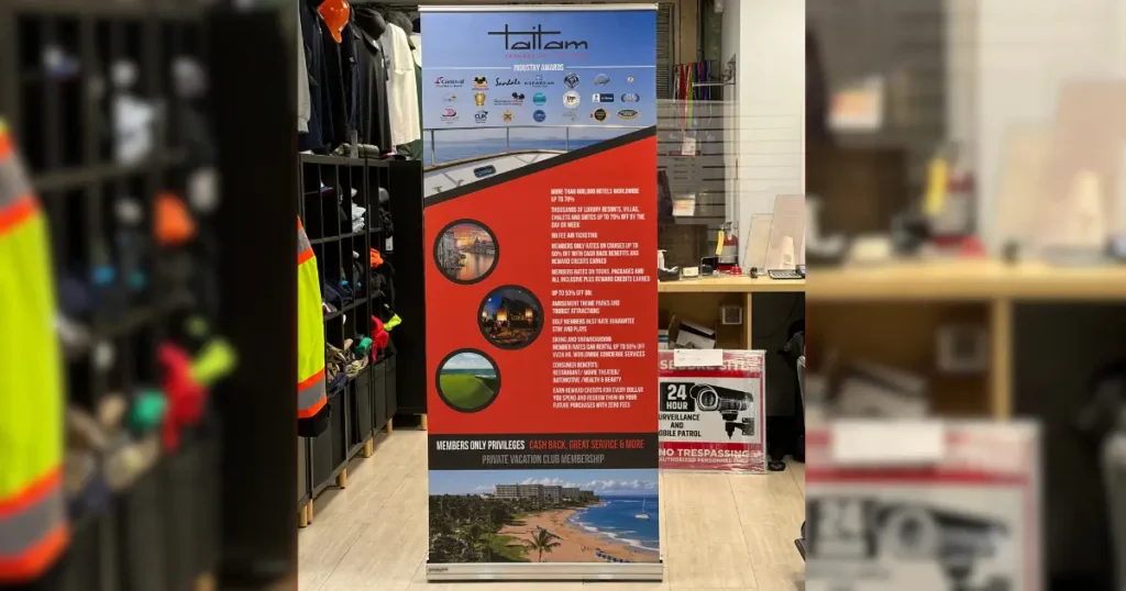 Roll-up printed banner displaying Taitam branding