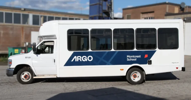 A Ford E450 Starcraft All Star showcasing bold Argo Bus decals and an eye-catching partial wrap.