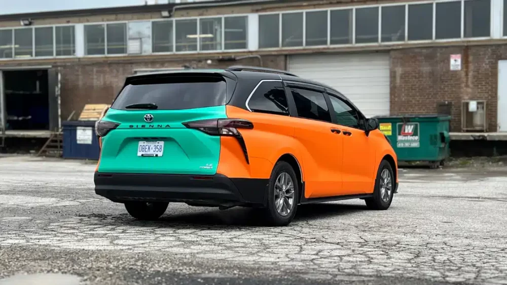 Beck Taxi wrap on Toyota Sienna. From passenger rear view.